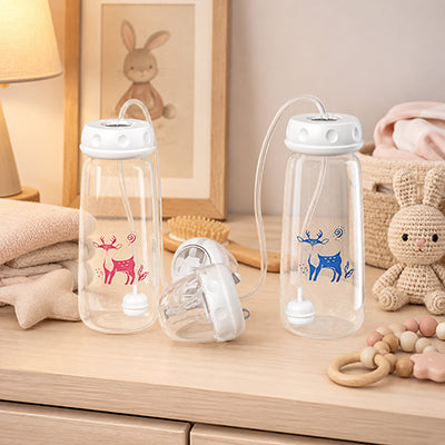 Biberon bleu et rose sur une commode de bébé