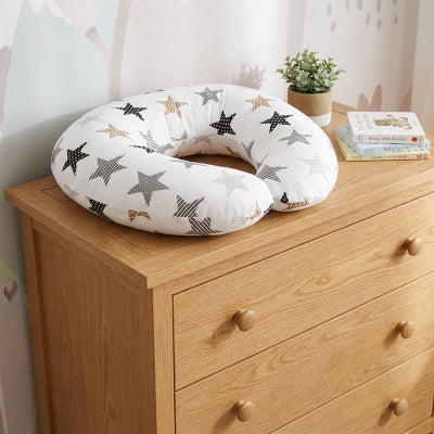 Coussin d'allaitement posé sur une commode