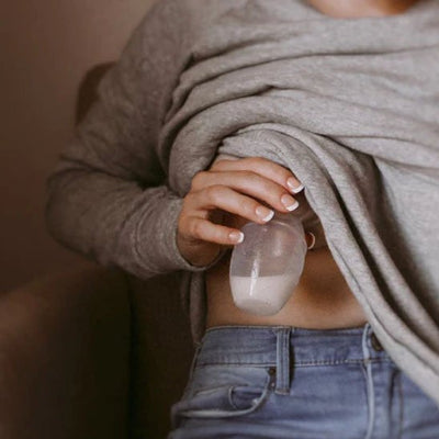 Femme utilise tire lait manuel sous chandail