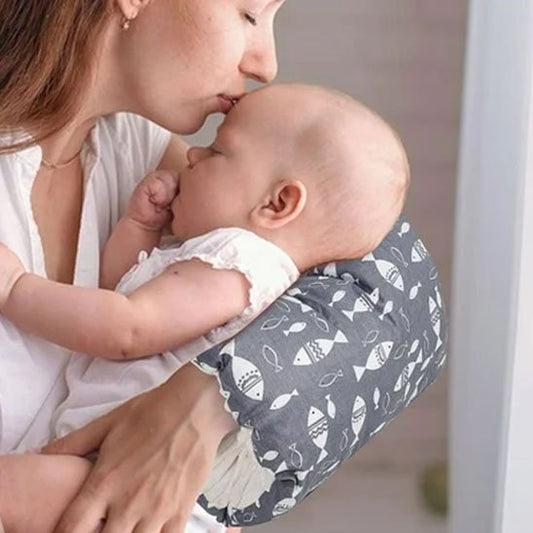 Maman embrasse bébé posé sur brassard d'allaitement